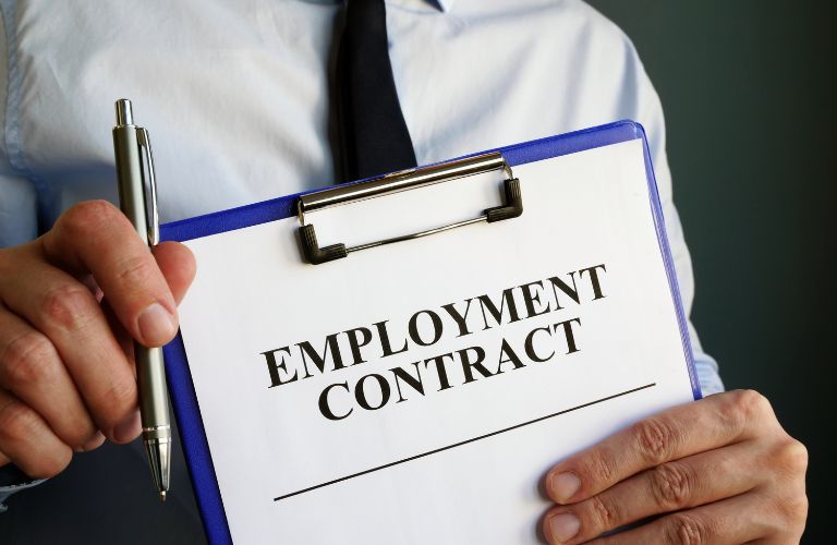 Man Holding Pen and Clipboard with Employment Contract