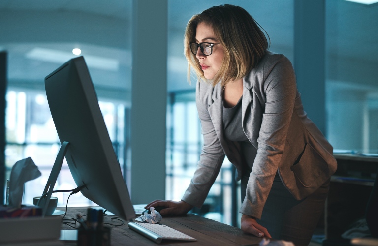 Woman reviewing applicants at a computer