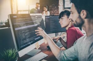 Man and Working on Code on Computers