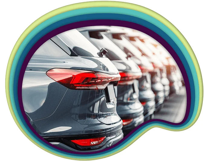 A car dealership featuring a prominent rainbow-colored circle in the foreground, showcasing a vibrant and welcoming atmosphere.